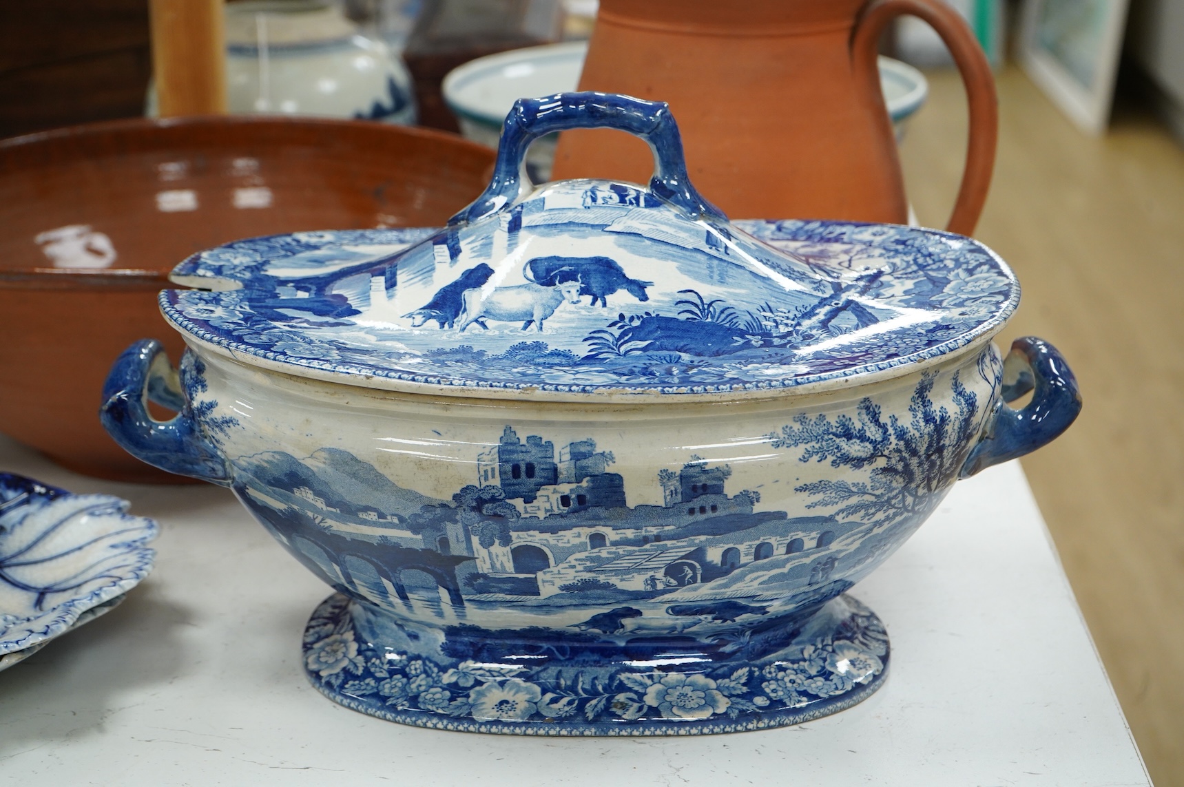 An early 19th century pearlware tureen, a pair of pearlware leaf dishes, a glazed earthenware jug and basin